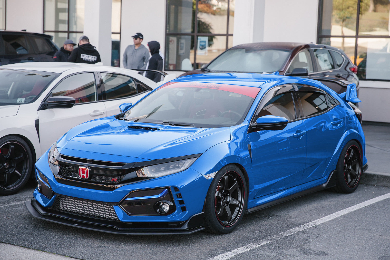 Blue Honda Civic Type-R FK8 on Volk Racing wheels with an aftermarket intercooler and splitters